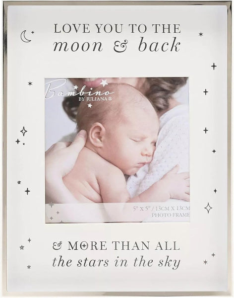A square white photo frame with decorative black text reading 'LOVE YOU TO THE moon & back' and '& MORE THAN ALL the stars in the sky,' plus small moon, star, and plus-sign motifs. A sample photo of a sleeping newborn is printed in the center, showing the frame's capacity for a photo insert.