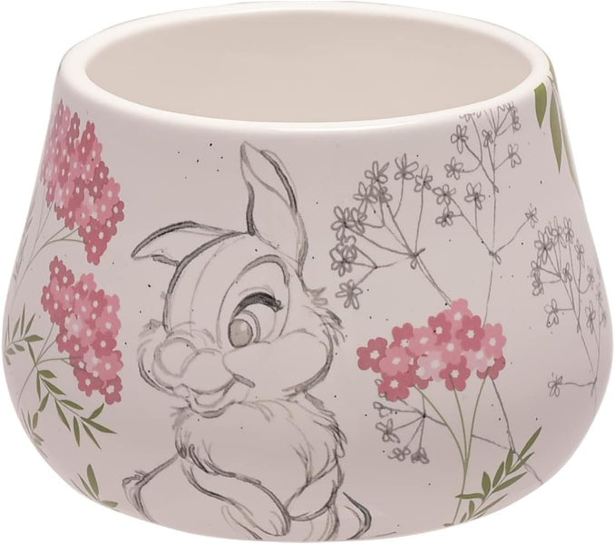 A white ceramic planter pot featuring a hand-drawn sketch of a bunny surrounded by pink flowers and green leaves.