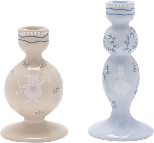Two decorative candle holders, one beige and one light blue, with intricate designs on a white background.