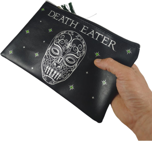 Black pouch with 'DEATH EATER' text and skull design held by a hand on a white background
