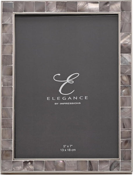A 5x7 picture frame with a gray insert card displaying the brand 'Elegance by Impressions' and dimensions. The frame features a border of small, polished gray and silver mother-of-pearl tiles.