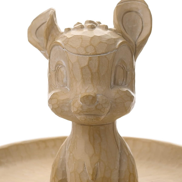 Beige ceramic deer-shaped object on a white background