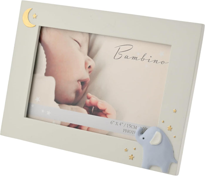 A baby-themed picture frame in a warm off-white/cream color, decorated with a gold crescent moon and stars in the top-left corner and a light blue elephant with gold stars in the bottom-right. The frame displays a photo of a sleeping baby with the word 'Bambino' written on it.