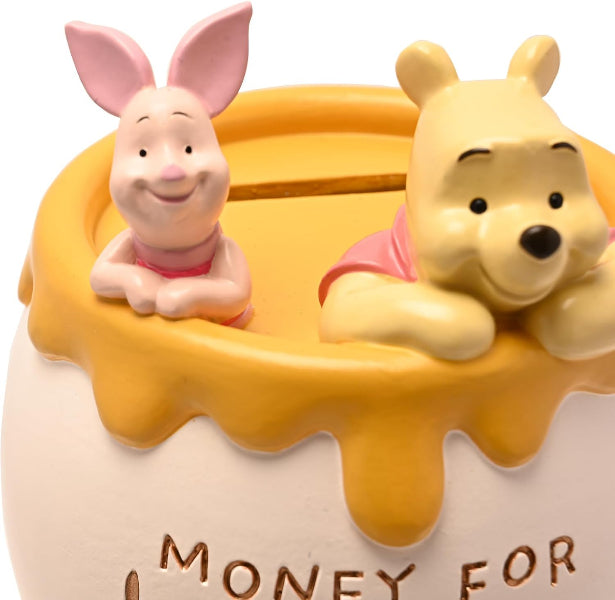 Two cartoon characters, a piglet and a bear, on top of a money box with 'Money For' text.