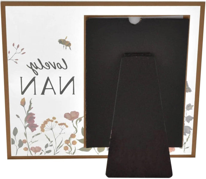 Decorative frame with floral design and text, containing two black rectangular objects.