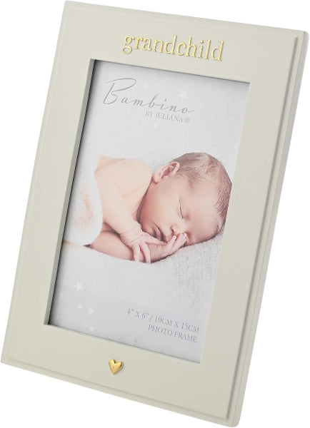 A cream-colored picture frame with gold lettering that reads 'grandchild' at the top and a small gold heart at the bottom. The frame is shown holding a sample baby photo insert, photographed on a clean white background.