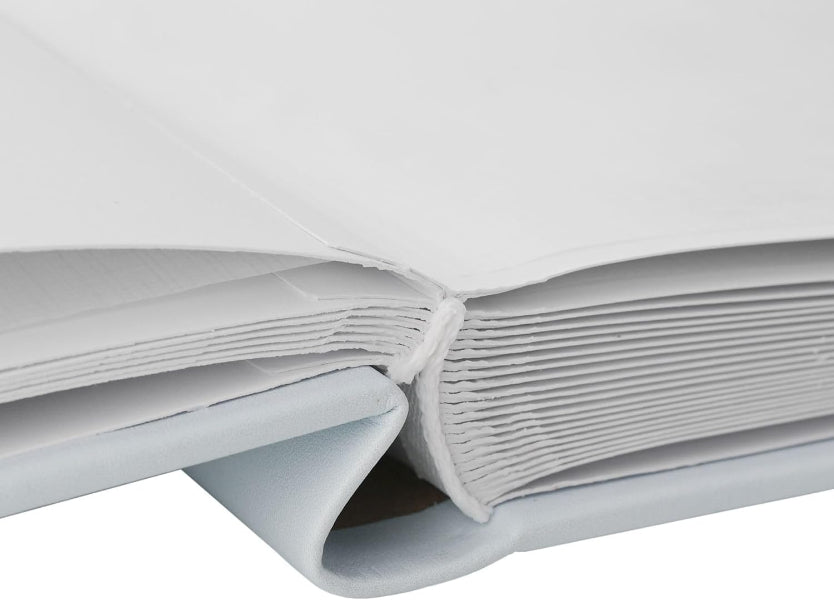 A close-up of a white binder with multiple white pages and a light blue-gray cover, photographed on a white background.