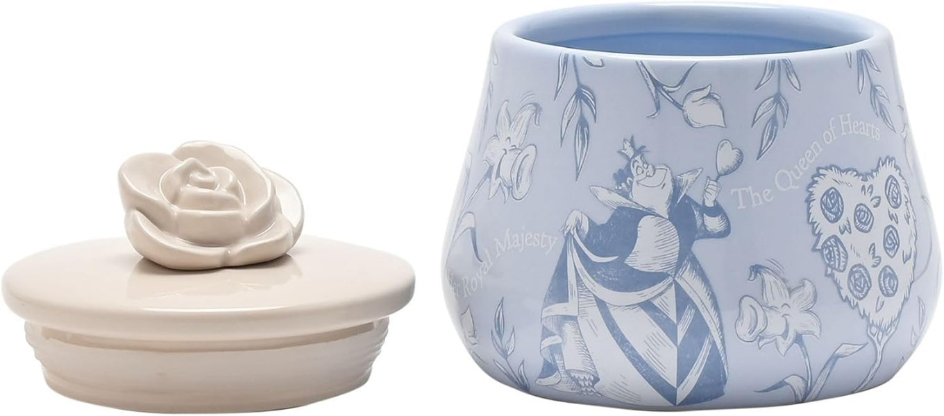 Ceramic container with lid featuring floral and character design on a light blue background