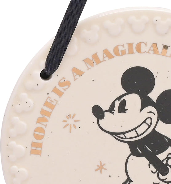 Round decorative item with Mickey Mouse design and 'Home is a Magical Place' text on a white background
