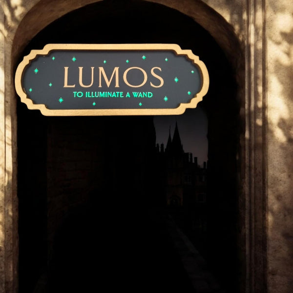 Decorative sign with 'LUMOS' text in a dark setting