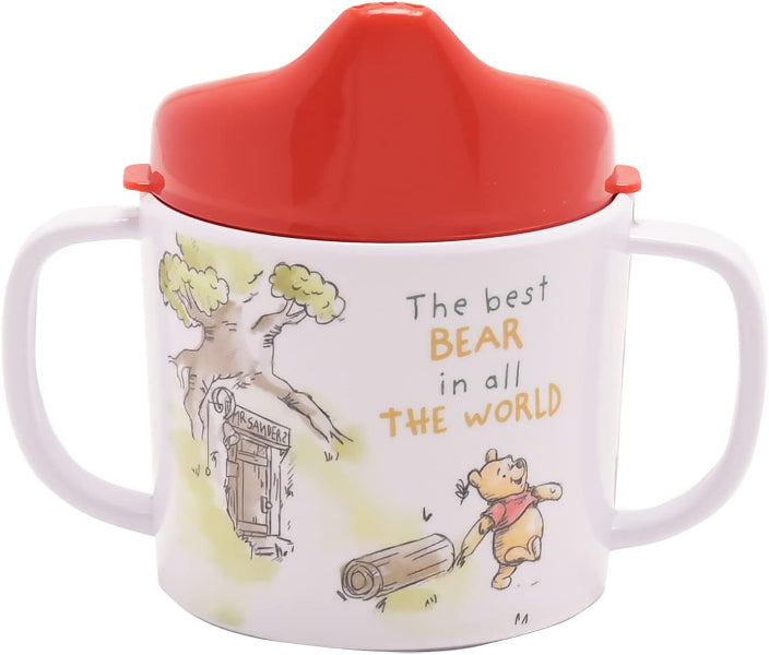 Children's sippy cup with red lid featuring a bear illustration and text on a white background