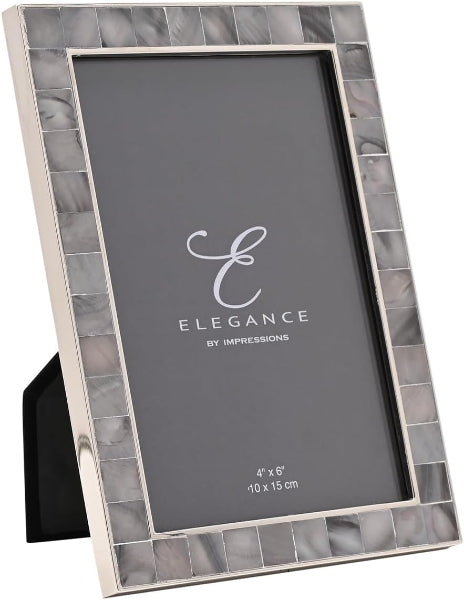 A 4x6 picture frame with a silver-toned metallic border and a mosaic of small gray and white marbled tiles around the edge. The frame is shown standing at an angle on a black display stand against a white background, with the brand name 'Elegance By Impressions' printed on the insert.