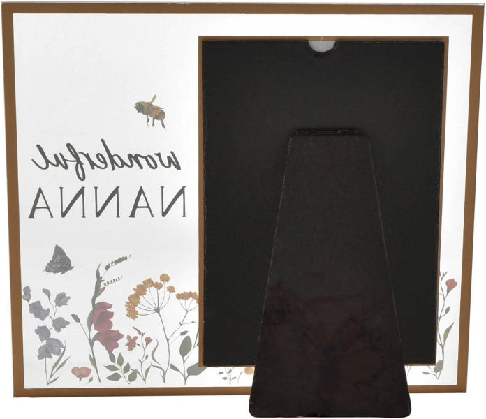 Two black phone cases in front of a decorative box with floral designs and text.