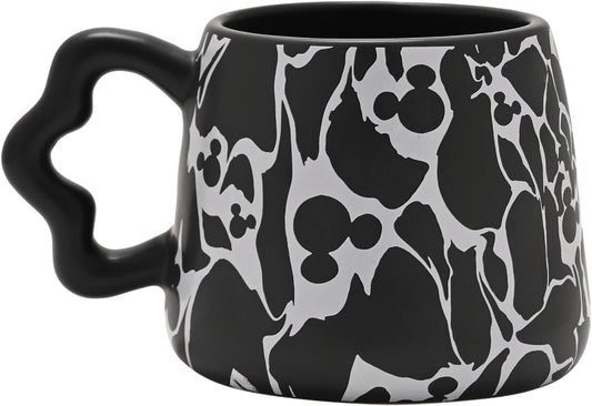 Black mug with white silhouette pattern on a white background