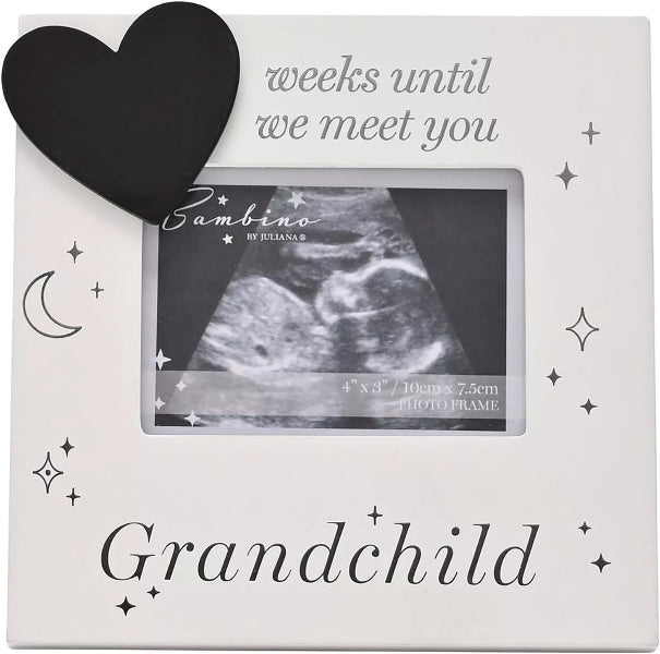 A square white photo frame with a black heart, crescent moon, and star illustrations. The top reads 'weeks until we meet you' and the bottom reads 'Grandchild.