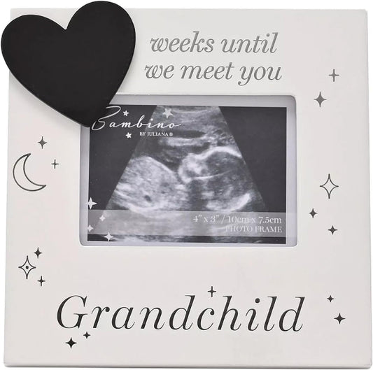 A square white photo frame with a black heart, crescent moon, and star illustrations. The top reads 'weeks until we meet you' and the bottom reads 'Grandchild.