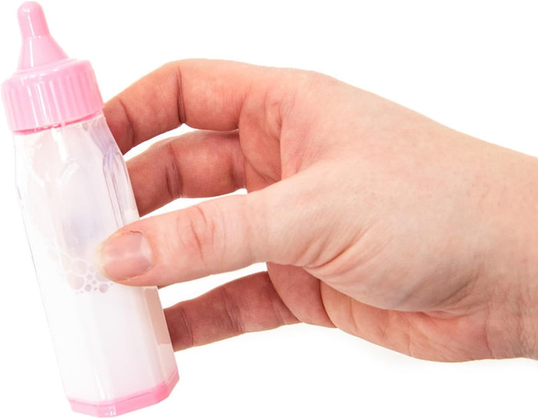 Hand holding a small pink and clear bottle against a white background