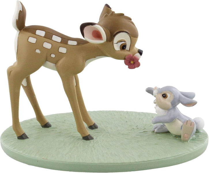 Figurine of a deer and a rabbit on a green base with a white background