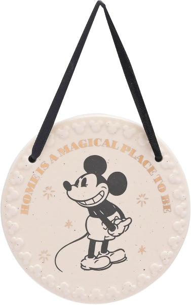 Round sign with Mickey Mouse design and text 'Home is a magical place to be' on a white background