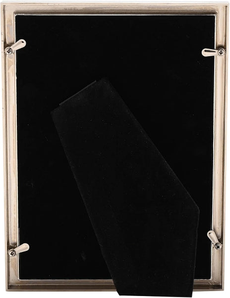 The back of a rectangular picture frame with a brushed silver metal border and four silver mounting screws, featuring a black velvet interior and a folded black presentation insert.