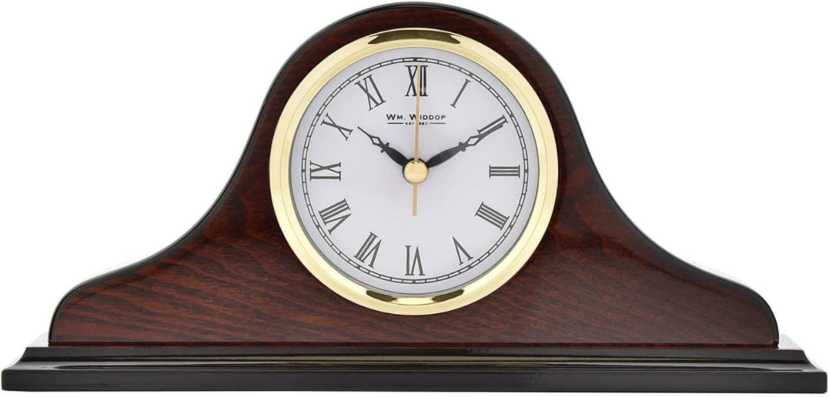 A classic mantel clock with a polished dark brown wood grain body, a gold-plated bezel, and a white dial with black Roman numerals and hands.