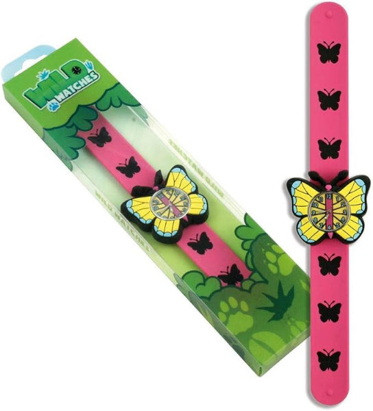 Pink butterfly watch shown next to its green retail packaging box on a white background. The watch has a bright pink strap decorated with black butterfly silhouettes and a large yellow and black butterfly charm on the wrist.