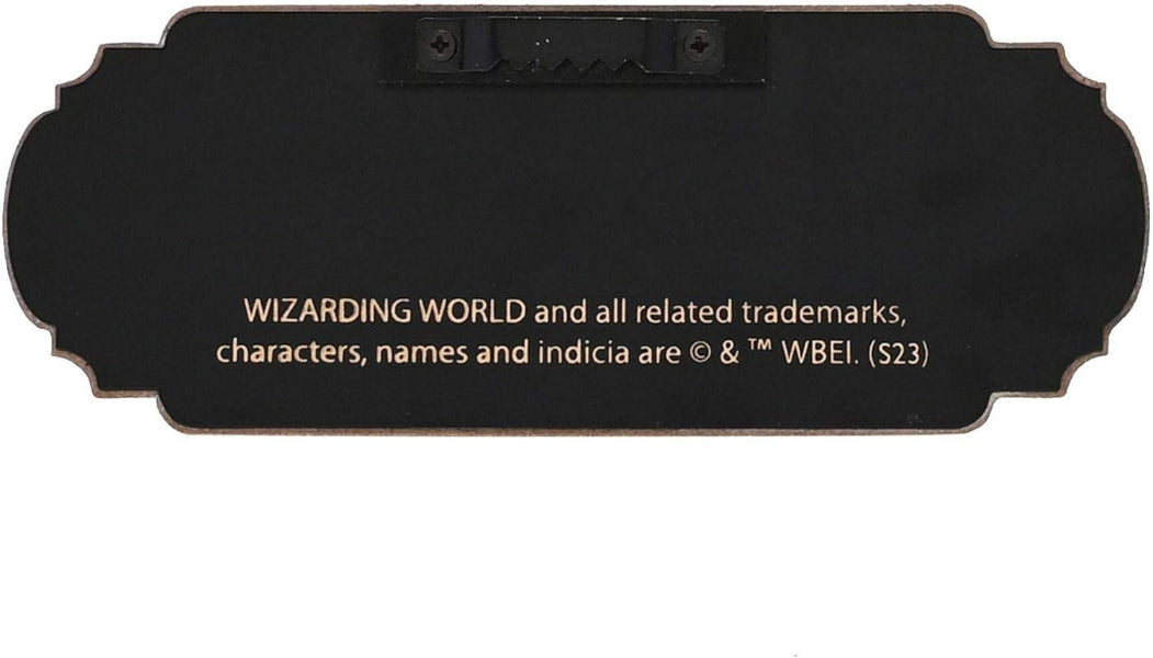 Black plaque with white text indicating 'Wizarding World' branding and copyright information.