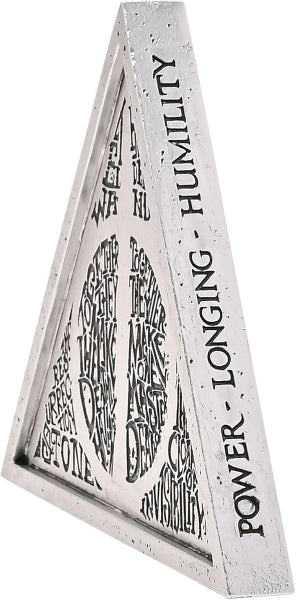 Triangular sculpture with engraved text on a white background