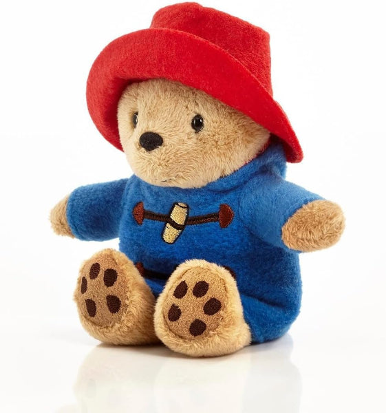 Plush toy bear wearing a red hat and blue outfit on a white background