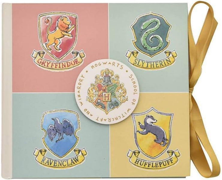 Notebook with Harry Potter Hogwarts house crests on a pink, green, blue, and yellow background.