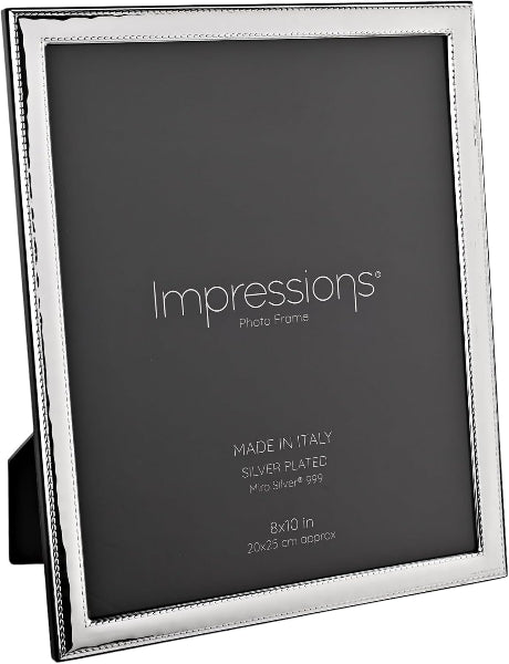 A silver-plated picture frame with a textured border, shown standing upright on a black display stand against a white background. The frame is labeled 'Impressions Photo Frame' with details 'MADE IN ITALY', 'SILVER PLATED', and '8x10 in'.