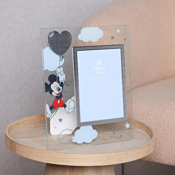 Glass photo frame with cartoon character holding a heart-shaped balloon on a wooden tray.