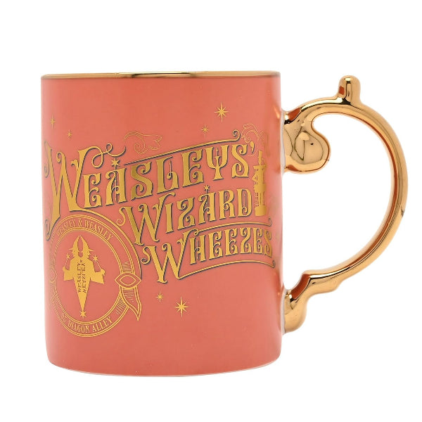Coral mug with gold handle featuring 'Weasleys Wizard Wheezes' text and logo.