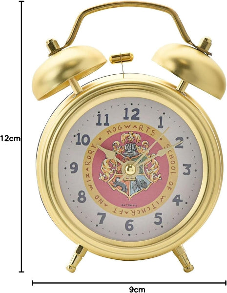 Gold alarm clock with Hogwarts crest design on a white background