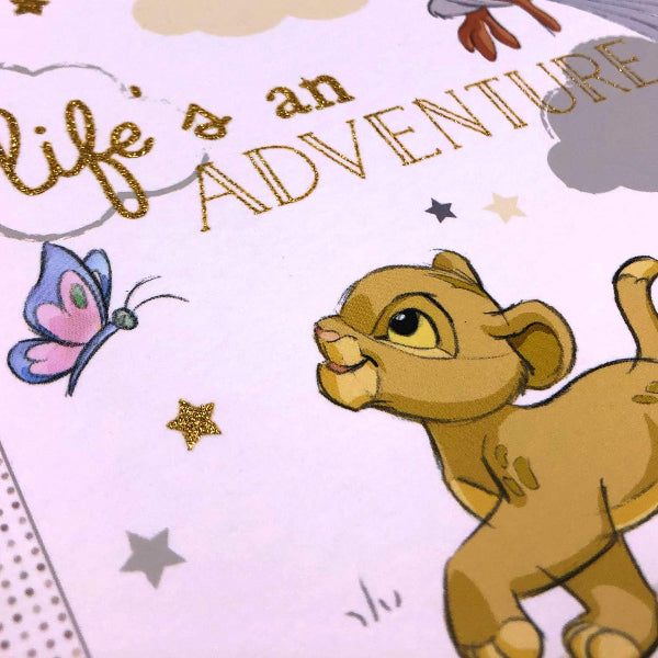 Cartoon lion cub with 'Life is an Adventure' text and butterfly on a light purple background