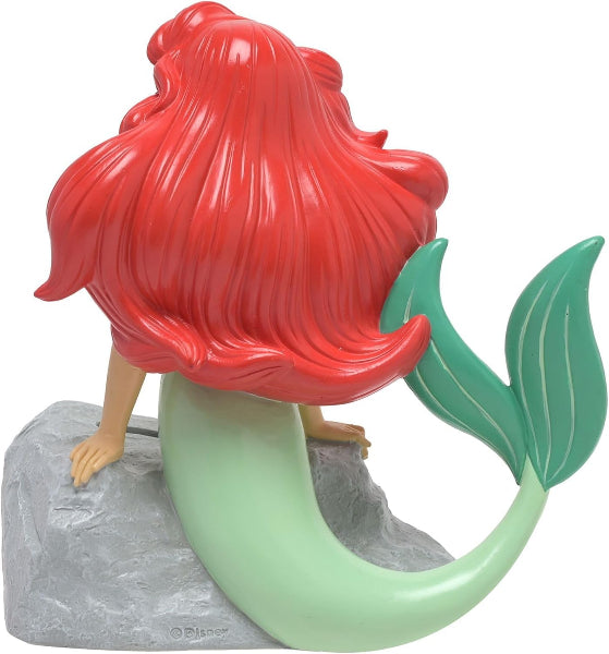 Mermaid figurine with red hair and green tail on a white background