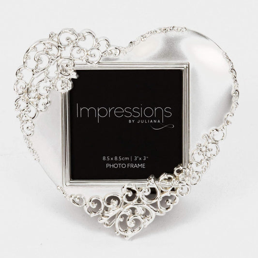 Decorative heart-shaped photo frame with intricate designs on a white background