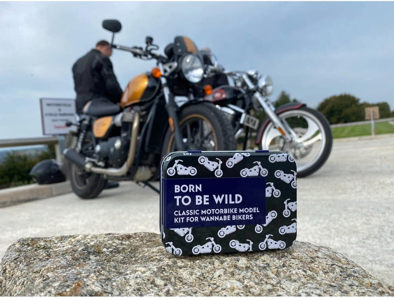 Motorcycle model kit packaging with a motorcycle in the background
