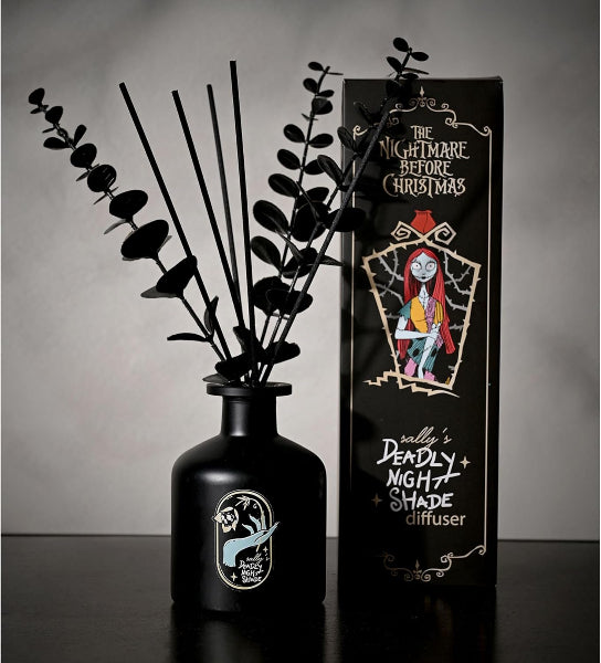 Black diffuser bottle with decorative sticks and packaging featuring 'The Nightmare Before Christmas' design.