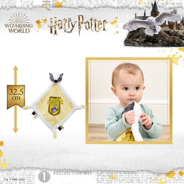 Baby holding a Harry Potter-themed toy with castle and owl in the background