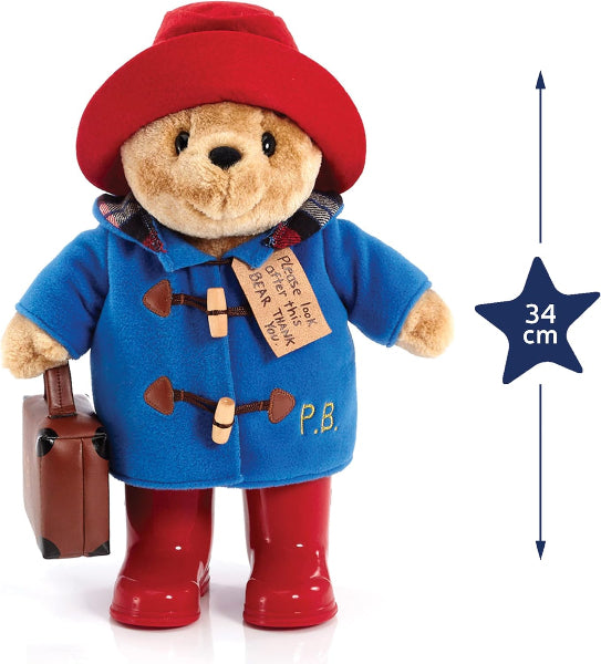Plush toy bear in a blue coat, red hat, and boots with a suitcase, size indicated by a star label.