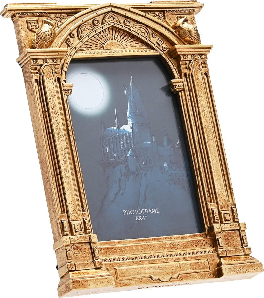 Decorative gold photo frame with a castle silhouette on a dark background