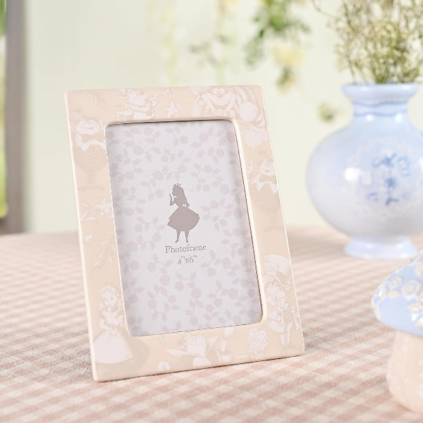 Floral-patterned photo frame on a textured surface with a blurred background