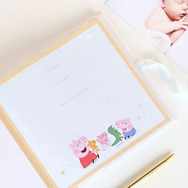 Framed picture of Peppa Pig and friends with a baby photo in the corner.