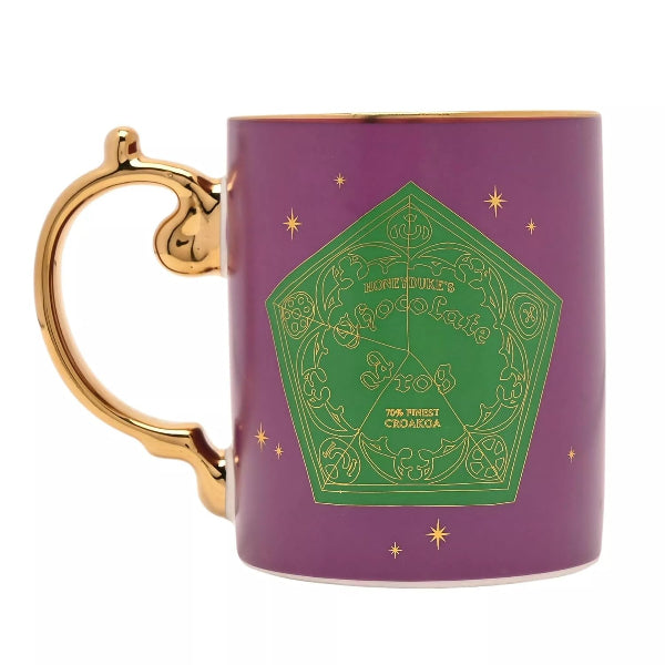 Purple mug with gold handle and green design on a white background