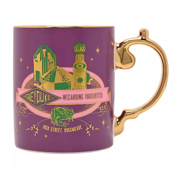 A purple ceramic mug with a gold handle and gold rim, featuring a 'Honey Duke: Wizarding Favourites' graphic with green and gold illustrations on a white background.