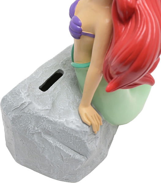 Mermaid figurine on a rock with a white background