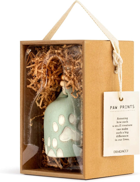 Decorative bell with paw prints in a gift box with a tag, featuring the brand 'Dekoroco'.