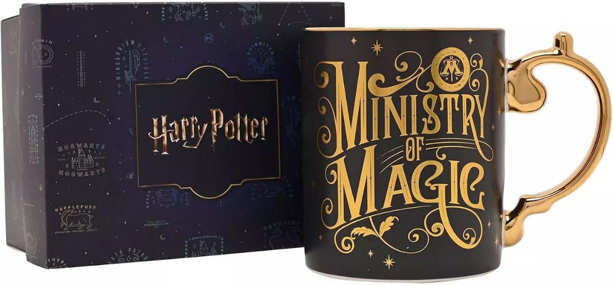 A black ceramic Harry Potter 'Ministry of Magic' mug with gold lettering and a gold handle, shown next to its dark blue branded gift box.