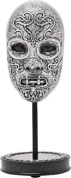 Decorative skull mask with intricate designs on a stand